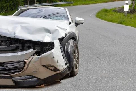 Front of light gray car big damaged and broken by accident on city street par Stock Photos