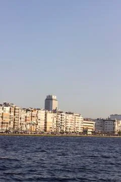 Front line of building blocks at sunset time near sea Stock-Fotos