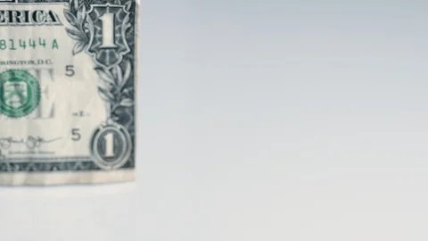 Front lit one dollar bill on white surface Stock Footage 124759220