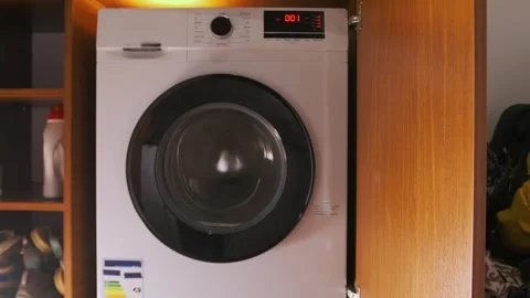 Front load washing machine in high speed spin cycle, drum rotating rapidly to Stock-Footage 333478759