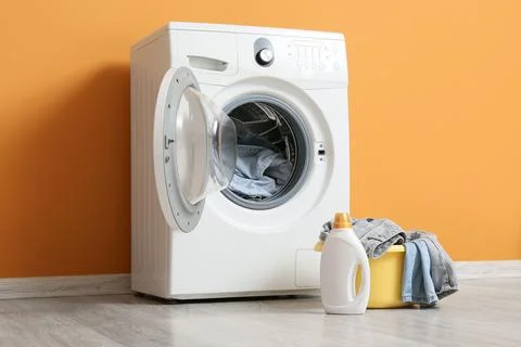 Front load washing machine with laundry detergent and clothes basket Stock Photos