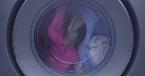 Front Load Washing Machine Spinning with Clothes inside with little foam Stock Footage 172379321
