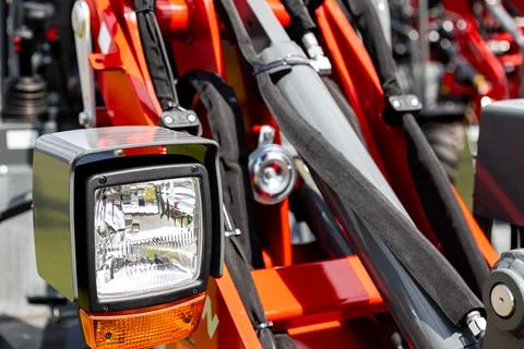 Front loader assembly with work light and hydraulic components Stock Photos