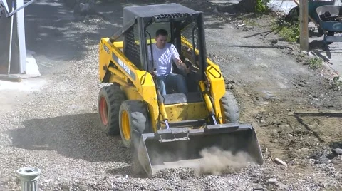 Front Loader construction crew removes dirt Stock Footage 61383431
