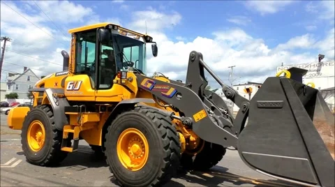 Front Loader drives down street Stock Footage 40494798