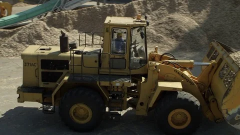 Front loader excavator driving about a factory Stock Footage 71294993