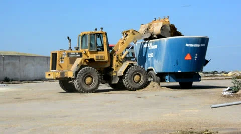 Front Loader Filling Cattle Feed Trailer 1 Stock-Footage 26466714