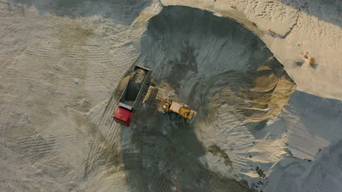 Front loader loading crushed stone into dump truck in quarry, aerial top down Stock Footage 165047133