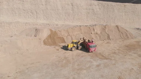 Front loader loads rubble into the body of a dump truck Stock Footage 164471436