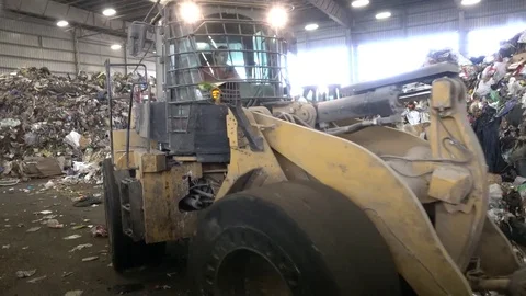 Front loader moving garbage at garbage transfer station Stock Footage 76168859