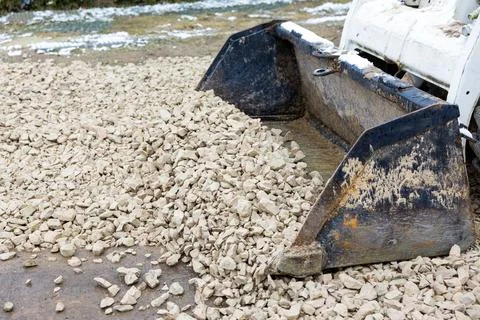 Front Loader Moving Rocks at Construction Site in Cold Environment Stock Photos