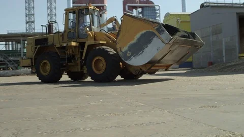 Front loader passing by at the wood processing factory Stock Footage 71270874
