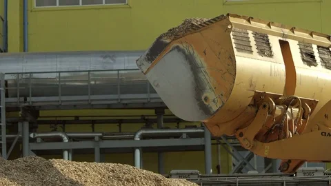 Front loader pouring wood chips from its bucket Stock Footage 71270959
