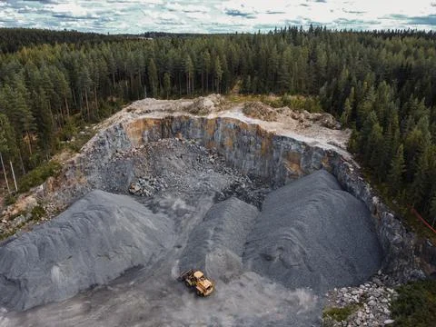 A front loader at the quarry in the middle of forest. Stock Photos