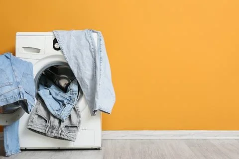 Front loading washing machine with denim clothes Fotos de archivo