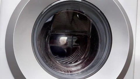 Front-Loading Washing Machine Drum Spinning Behind Glass Door Video stock 330359011