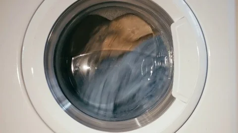 A front loading washing machine washing process medium shot timelapse  Stock Footage 73901530