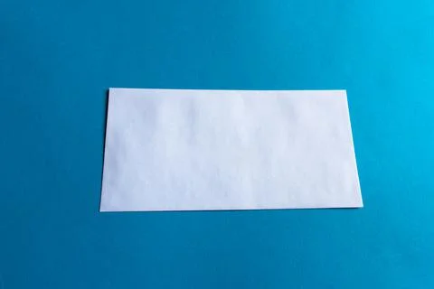 Front of Long, Rectangular White Envelope on Blue Background Stock-Fotos