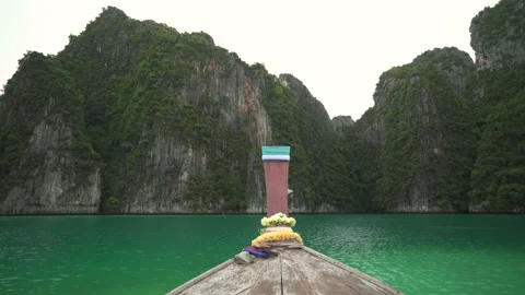 Front of long tail boat floating on water going to defile between mountain Stock Footage 141317723