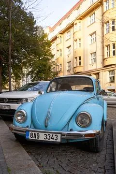 Front low angle view of vintage light blue Volkswagen VW Beetle car parked on Stock Photos