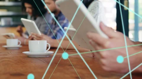 Front man tapping tablet screen and starting blue node overlay linking devices Stock Footage 333720284