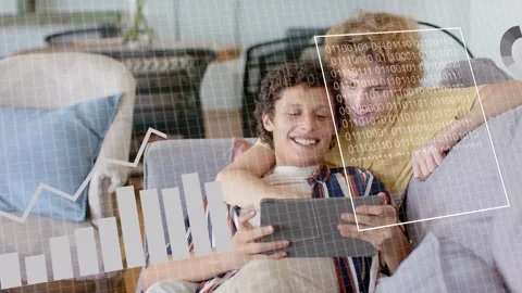 Front man tapping tablet, two men on sofa sharing device activating tech chart Stock Footage 333790012