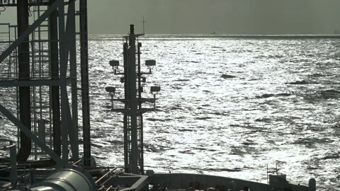 Front mast of ship pitching of sea. Water in glare of sun. Mast silhouette Stock Footage 245396274