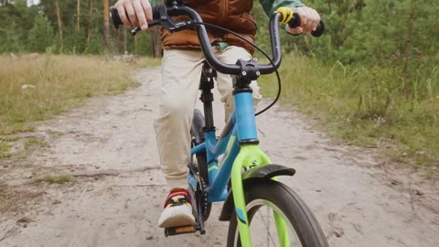 Front medium shot of boy cycling outdoor exercise Stock Footage 316581747