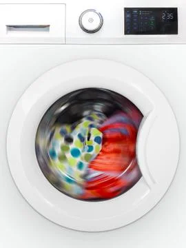 Front of a modern electronic washing machine with rotating colorful laundry Stock Photos