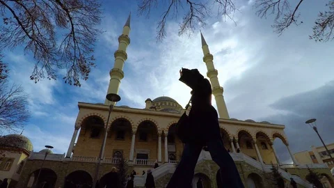 In front of a mosque behind sun Stock Footage 102782938