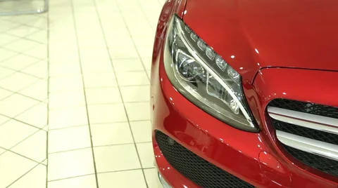 The front of the new red car. Headlight of the new machine. View of row new car Stock Footage 68811640