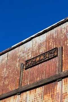 The front of an old building covered in rust. Stock Photos