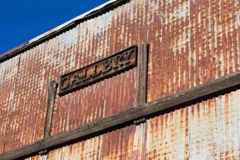 The front of an old building covered in rust. Stock Photos