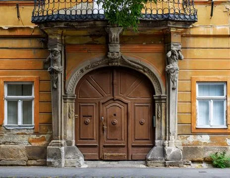 Front of the old building (facade), historic wooden door (gate). Architecture Stock Photos