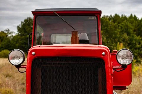 The front of an old tractor standing in a field Stock Photos