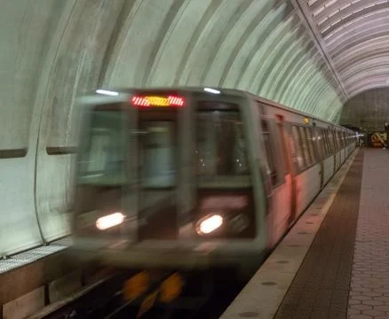 Front of older model subway train pulling into station Stock Photos