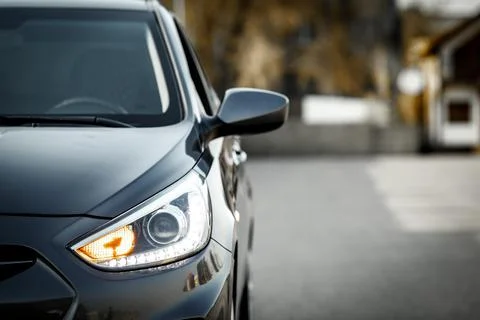Front optics and side rear view mirror of a gray car Hyundai Accent with copy Stock Photos