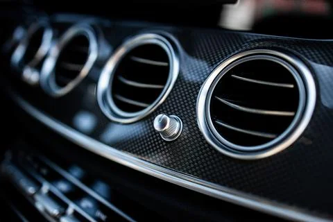Front panel in a luxury car with ventilation and climate control Stock Photos