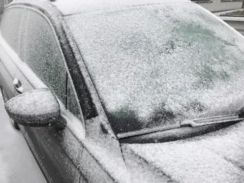 Front of parked car close up of windshield in cold snow weather Stock Photos