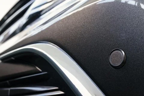 Front parking sensor on a fender of modern car Stock Photos