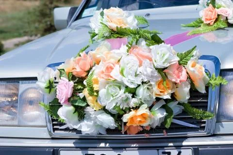 The front part of the car decorated with artificial flowers Stock Photos