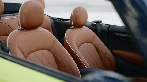 Front passenger and driver seats in premium brown leather interior of Mini Stock Footage 261247700
