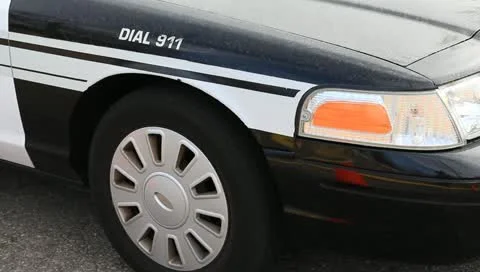 Front of police car with emergency lights flashing Stock Footage