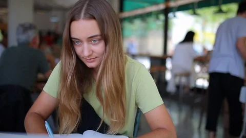 Front portrait female writes in notebook 動画素材 127695294