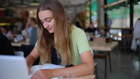 Front portrait female writes in notebook Stock Footage 127695324