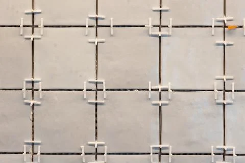 A front portrait of a tile wall under construction. The wall is being tiled.. Stock Photos