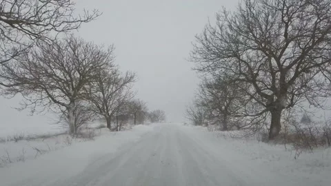 Front PoV driving in blizzard on icy road. Concept: Dangerous driving, hazardous Stock Footage 148367442