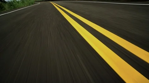 Front pov view of fast car driving on rural road Stock Footage