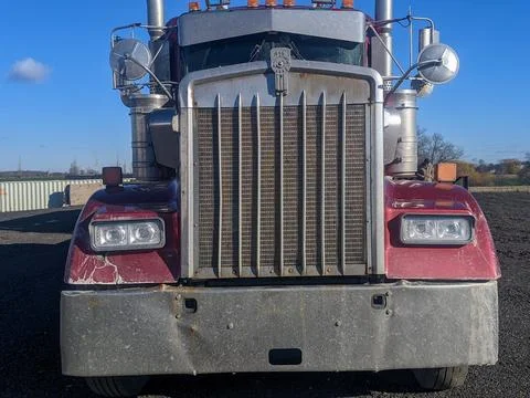 The Front of a Powerful Big Rig Red Semi Truck with Chrome Grill Stock-Fotos