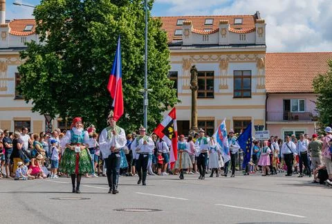 Front of the procession with flags in folk costumes Stock Photos